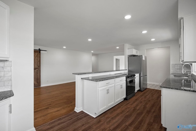 2707 Morgan St SW, Huntsville, AL 35805 - kitchen with electric stove, freestanding refrigerator, a barn door, a sink, and dark wood-type flooring