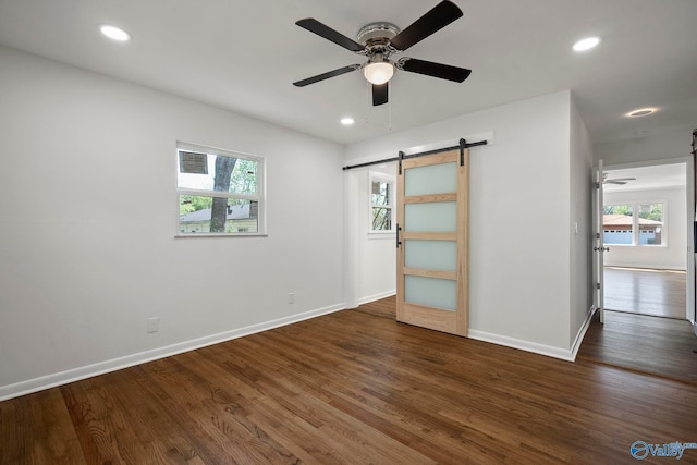 2707 Morgan St SW, Huntsville, AL 35805 - spare room featuring a barn door, plenty of natural light, a ceiling fan, and baseboards
