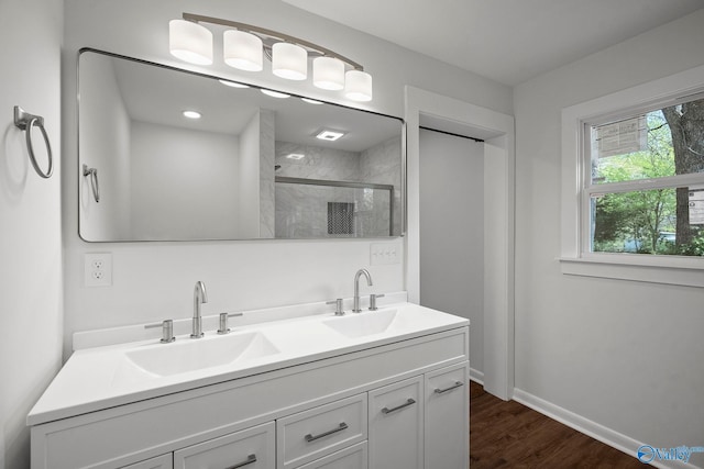 2707 Morgan St SW, Huntsville, AL 35805 - full bath featuring double vanity, wood finished floors, a stall shower, and a sink