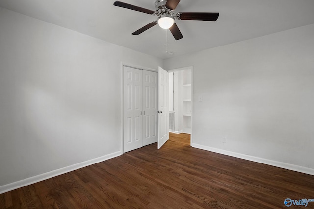 2707 Morgan St SW, Huntsville, AL 35805 - unfurnished bedroom with baseboards, ceiling fan, a closet, and dark wood-type flooring
