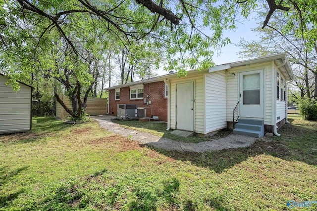 2707 Morgan St SW, Huntsville, AL 35805 - back of house featuring central AC, fence, entry steps, and a yard