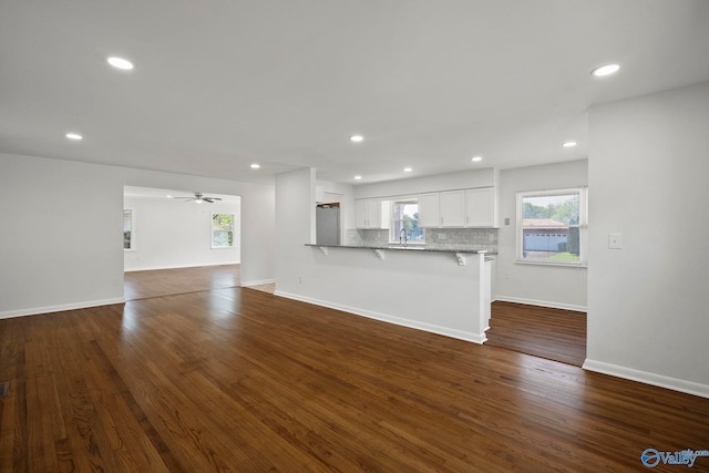 2707 Morgan St SW, Huntsville, AL 35805 - unfurnished living room featuring a sink, ceiling fan, baseboards, recessed lighting, and dark wood-type flooring