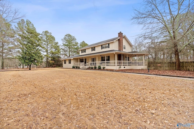 rear view of house featuring a porch