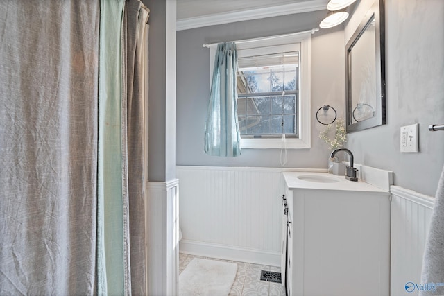 bathroom with vanity, ornamental molding, and tile patterned flooring