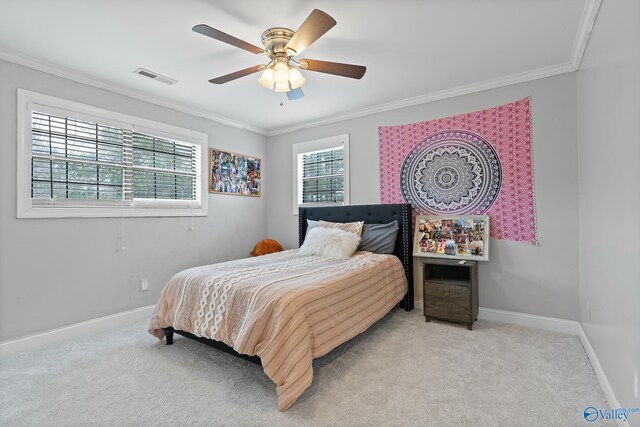 carpeted bedroom featuring ceiling fan and ornamental molding