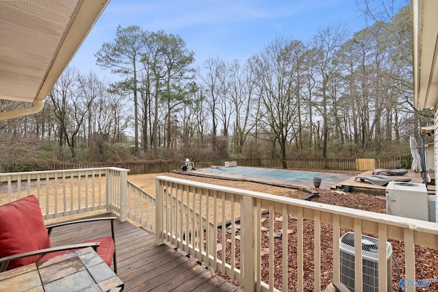 deck with a covered pool and central AC unit