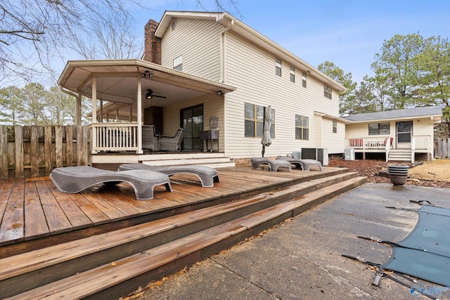 back of house featuring ceiling fan, a swimming pool side deck, and central air condition unit