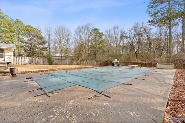 view of swimming pool featuring a diving board