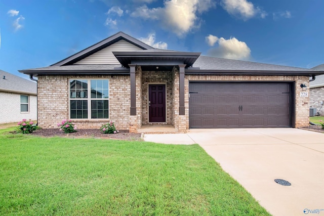 228 Cherry Laurel Dr, Hazel Green, AL 35750 - view of front of home featuring brick siding, a garage, concrete driveway, and a front yard