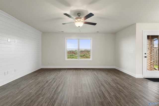 228 Cherry Laurel Dr, Hazel Green, AL 35750 - empty room with healthy amount of natural light, dark wood-style floors, wooden walls, and ceiling fan