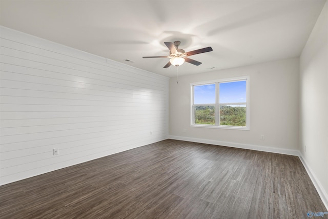 228 Cherry Laurel Dr, Hazel Green, AL 35750 - spare room with dark wood-type flooring, ceiling fan, and wood walls