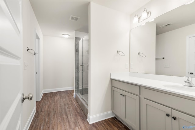 228 Cherry Laurel Dr, Hazel Green, AL 35750 - bathroom featuring vanity, a stall shower, and wood finished floors