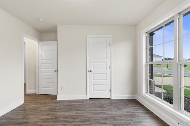 228 Cherry Laurel Dr, Hazel Green, AL 35750 - unfurnished bedroom with dark wood-type flooring and multiple windows