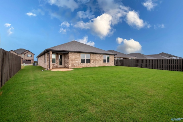 228 Cherry Laurel Dr, Hazel Green, AL 35750 - back of property with brick siding, a patio area, and a fenced backyard