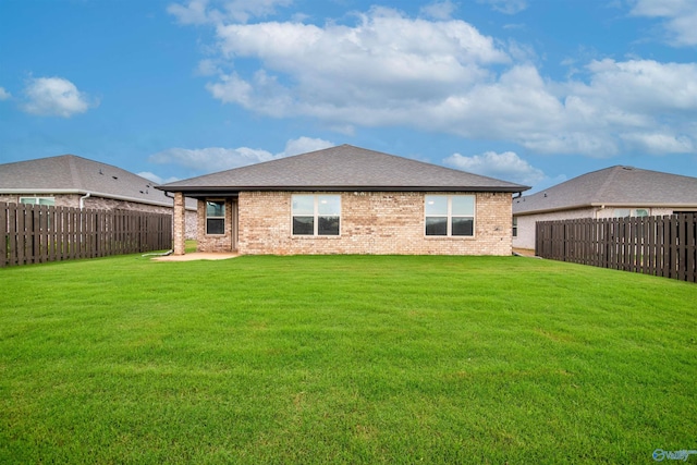228 Cherry Laurel Dr, Hazel Green, AL 35750 - back of house featuring a fenced backyard, brick siding, and a patio area