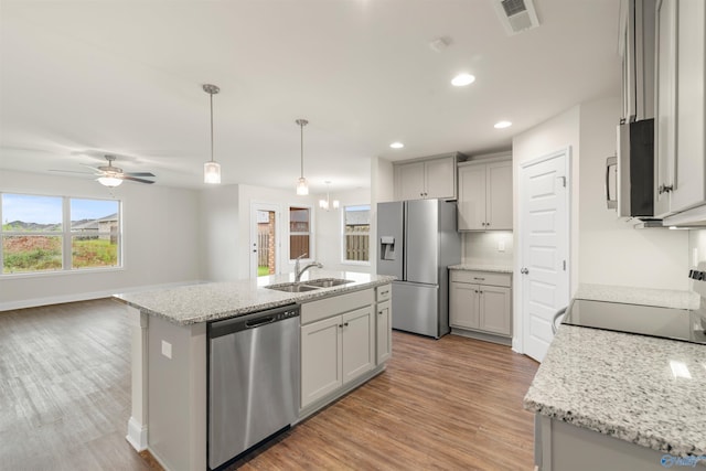 228 Cherry Laurel Dr, Hazel Green, AL 35750 - kitchen with appliances with stainless steel finishes, light wood-style flooring, recessed lighting, gray cabinets, and decorative light fixtures