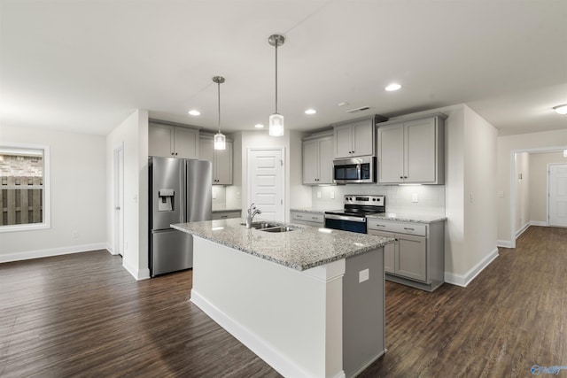 228 Cherry Laurel Dr, Hazel Green, AL 35750 - kitchen with appliances with stainless steel finishes, gray cabinets, dark wood finished floors, a center island with sink, and backsplash