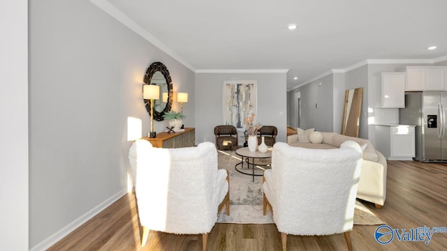 living room with wood-type flooring and ornamental molding