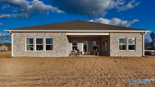 back of house with a yard and a patio