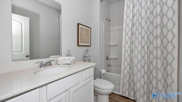 full bathroom with vanity, wood-type flooring, shower / tub combo, and toilet