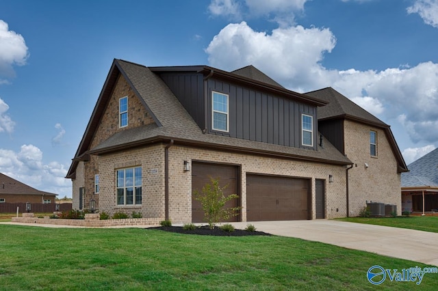 craftsman house featuring a front lawn, driveway, board and batten siding, an attached garage, and brick siding