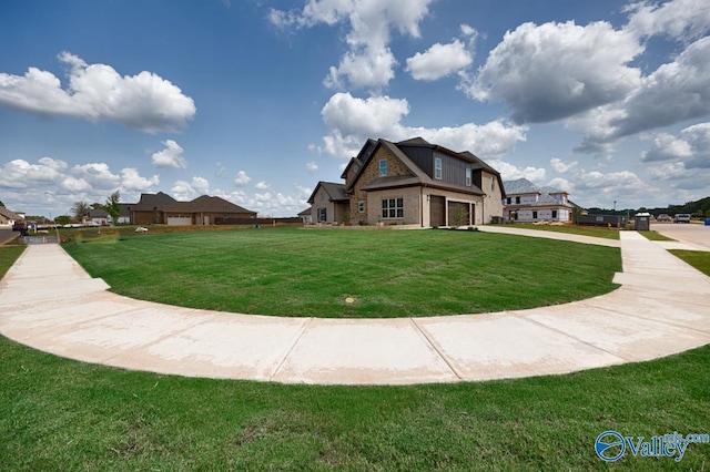 exterior space with a lawn, an attached garage, and concrete driveway