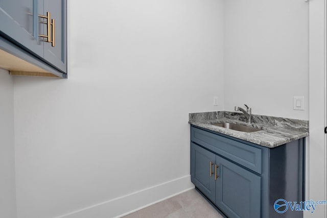 bathroom featuring baseboards, tile patterned flooring, and vanity