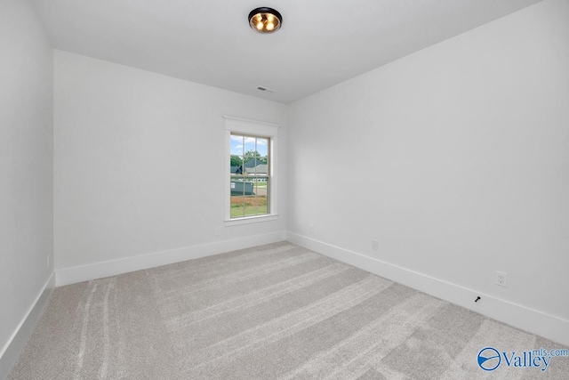 empty room with visible vents, baseboards, and carpet floors
