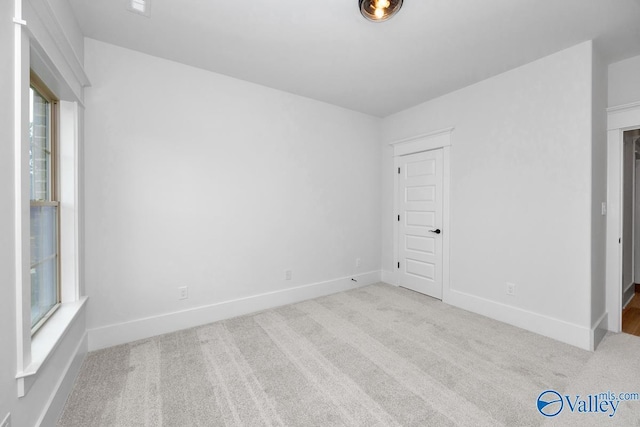 unfurnished bedroom with baseboards and carpet flooring