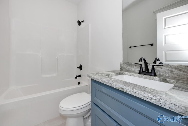 full bath featuring toilet, vanity, and shower / washtub combination