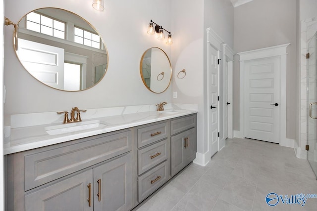 full bath featuring a shower stall, tile patterned floors, a sink, and double vanity