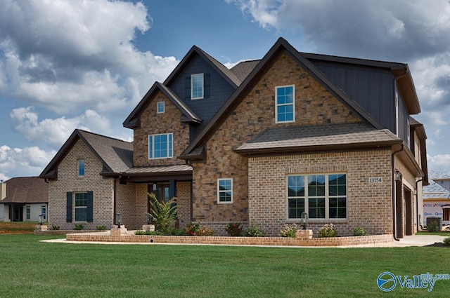craftsman house with brick siding, stone siding, a front lawn, and a garage