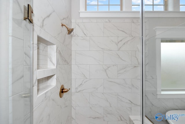 bathroom featuring toilet and tiled shower