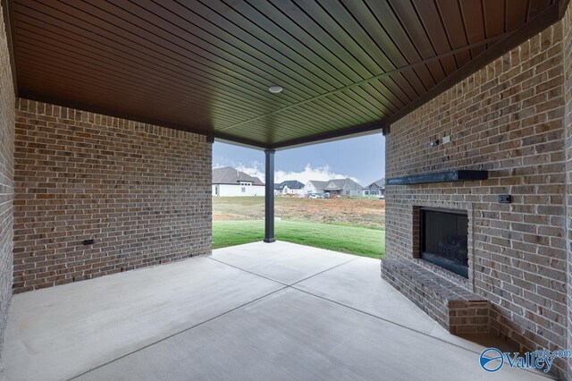 view of patio / terrace with a residential view and an outdoor brick fireplace