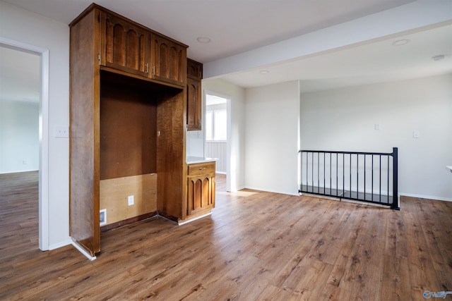 kitchen with dark brown cabinets and hardwood / wood-style flooring