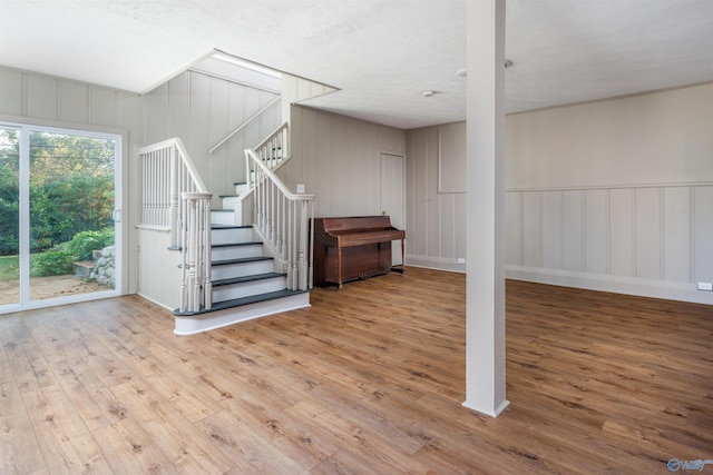 basement with wood-type flooring and a textured ceiling