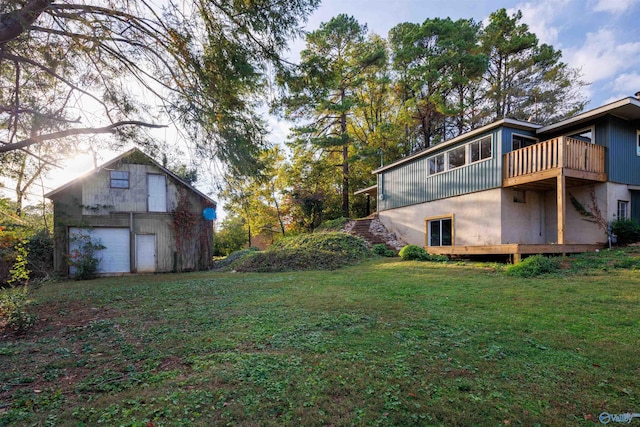 view of yard featuring a garage and a balcony