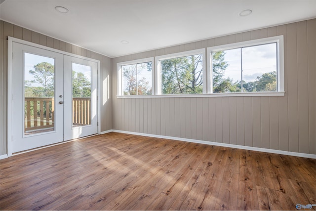 unfurnished sunroom with plenty of natural light and french doors