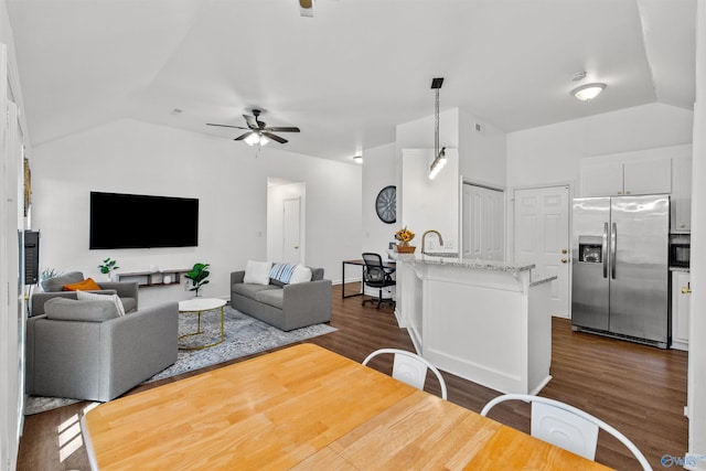 living area with a ceiling fan, dark wood-type flooring, and lofted ceiling