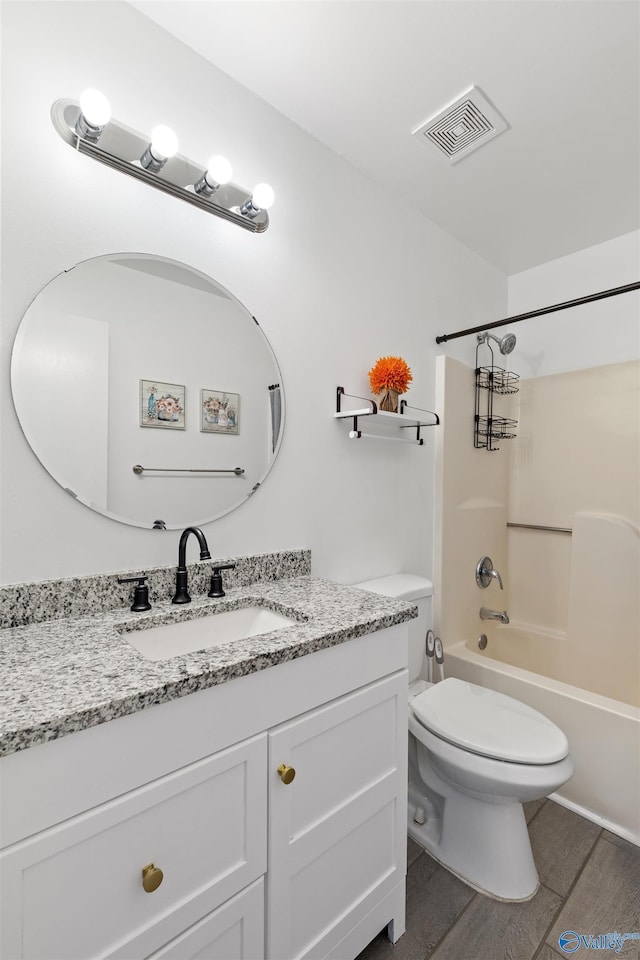 full bathroom with visible vents, toilet, wood finished floors, shower / bath combination, and vanity