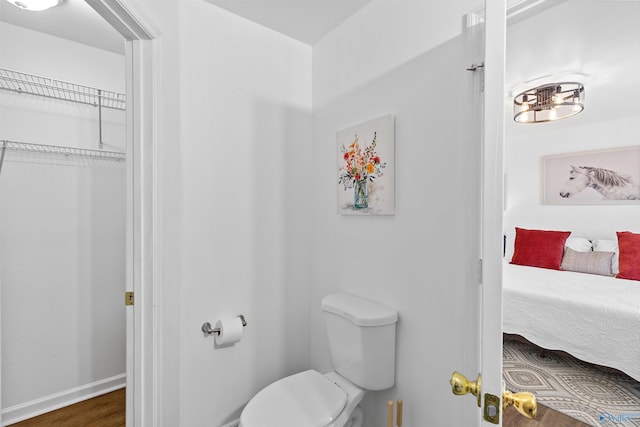 bathroom featuring toilet and wood finished floors