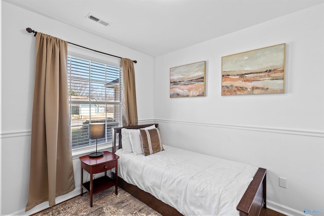 bedroom featuring visible vents and baseboards