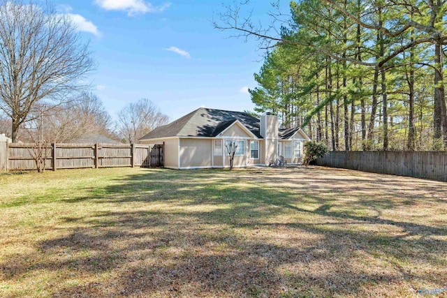 view of yard with a fenced backyard