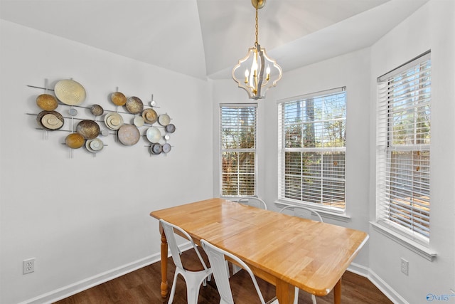 dining space featuring baseboards, lofted ceiling, an inviting chandelier, and dark wood-style flooring