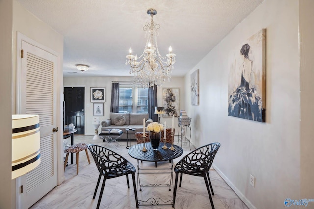 dining space with marble finish floor, baseboards, and a chandelier