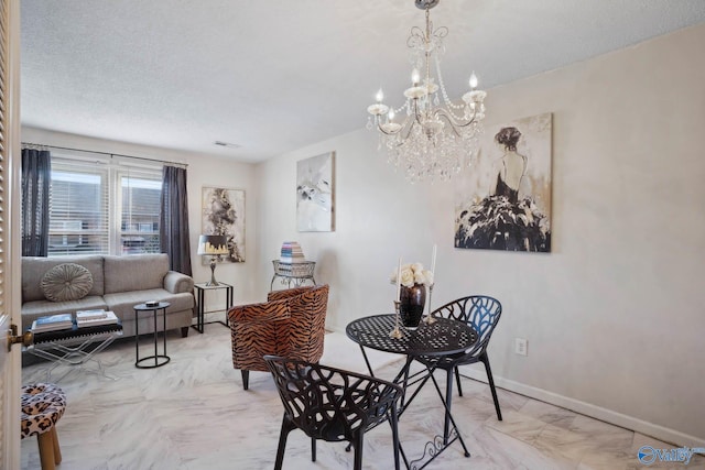 dining area featuring a textured ceiling, a notable chandelier, visible vents, and baseboards