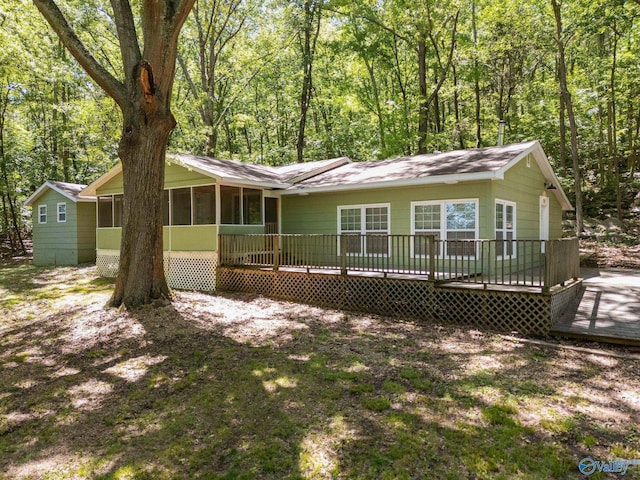 228 George Byrd Dr, Owens Cross Roads, AL 35763 - view of front facade with a deck, a sunroom, and roof with shingles