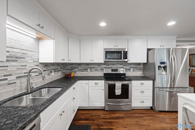 228 George Byrd Dr, Owens Cross Roads, AL 35763 - kitchen featuring appliances with stainless steel finishes, a sink, white cabinetry, backsplash, and recessed lighting