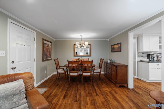 228 George Byrd Dr, Owens Cross Roads, AL 35763 - dining room with baseboards, dark wood finished floors, a chandelier, and crown molding