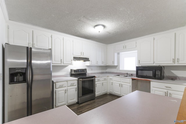 kitchen with sink, stainless steel appliances, a textured ceiling, white cabinets, and dark hardwood / wood-style flooring